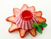 Strawberry slices with strawberry jelly cream and leaves on white background