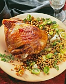 Golden brown turkey thigh with lentils on plate