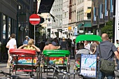 Commuters travelling in pedicab at Amager Square in Copenhagen, Denmark