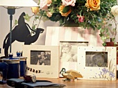 Close-up of picture frames with lamp on table