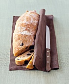 Olive ciabatta on brown napkin