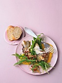 Warm oyster with mushroom salad on pink background