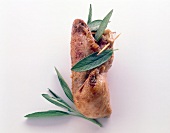 Stuffed chicken leg with herbs and toothpick in it