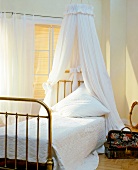 White bed with white canopy