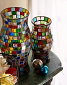 Close-up of two lanterns with glass mosaic