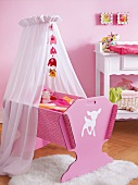 Children's room with pink cradle under canopy on fur rug