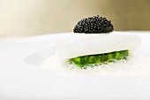 Close-up of sole fillet with caviar and terrine spinach