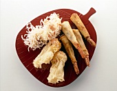 Deep fried shrimp, wontons and shrimp snacks on red tray