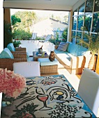 Tile painted table and wicker furniture in a villa, Saint-Tropez, France