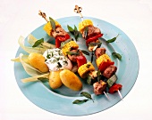 Meat and vegetables skewers on blue plate