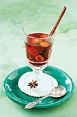 Close-up of winter punch with cinnamon, star anise, red wine and kumquats in glass