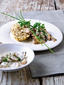 Pretzel dumplings with mushroom ragout and herbs on plate