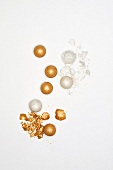 Gold and beige shiny mineral make-up balls on white background