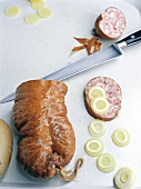 Pork sausage sliced with knife, overhead view