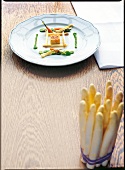 White asparagus with vanilla, carrots, broad beans and young leeks on plate