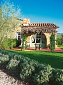 View of room with terrace and garden in 'Le Case del Borgo' lodge, Tuscany, Italy
