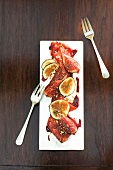Dried beef with melted figs on serving dish