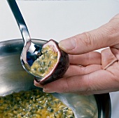 Scooping flesh of passion fruit with spoon, step 3