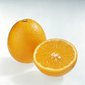 Halved and whole pera orange on white background