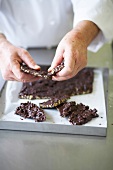 Close-up of chef breaking chocolate into pieces