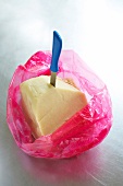 Almond paste with knife in pink plastic bag