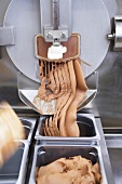 Chocolate ice cream being prepared by ice machine