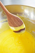 Butter being mixed with flour, eggs and sugar