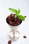 Chocolate sorbet with mint leaf in ice cream bowl