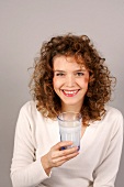 Woman holding glass of milk in hand