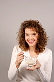 Woman holding dessert bowl in hand