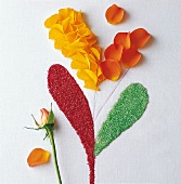 Indien - Motiv aus Farbe und Blütenblättern, Blütenblätter legen
