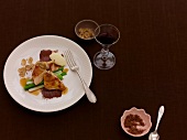 Guinea fowl breast in hazelnut oil with dark chocolate and chestnuts on plate