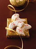 Walnut kipferl (crescent-shaped biscuits) with icing sugar on a golden square