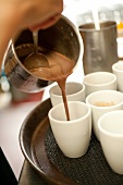 Close-up of cups filled with chocolate drink