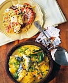 Noodle paella on plate and noodle stew with fish in bowl, Andalusian, Spain