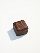 Piece of dark chocolate on white background