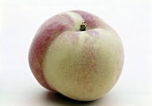 Close-up of white fleshy peach on white background