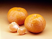 Whole and piece of mandarin orange