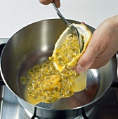 Hand adding pulp of passion fruit in pot