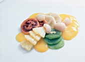 Fruit salad with exotic fruits on white background