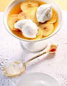 Snow eggs on cardamom apples in bowl with gold fork