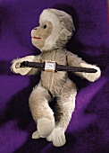 Stuff toy with 40's style watch in brown on purple background