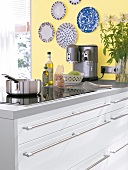 Work surface in white against yellow wall in kitchen