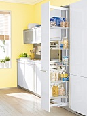 Extendable apothecary cabinet in white and yellow in kitchen