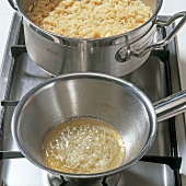 Close-up of long grain rice in casserole and melting butter in saucepan, step 3