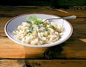 Risotto with gorgonzola cheese and fennel leaves on plate