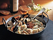 Risotto with seafood, clams and mussels in wok