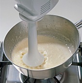 Close-up of sauce being mixed with pitch rod, step 8
