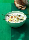 Horseradish and cucumber soup with ham in bowl