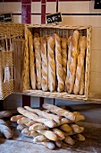 Baguettes in wicker basket with price tag in bakery